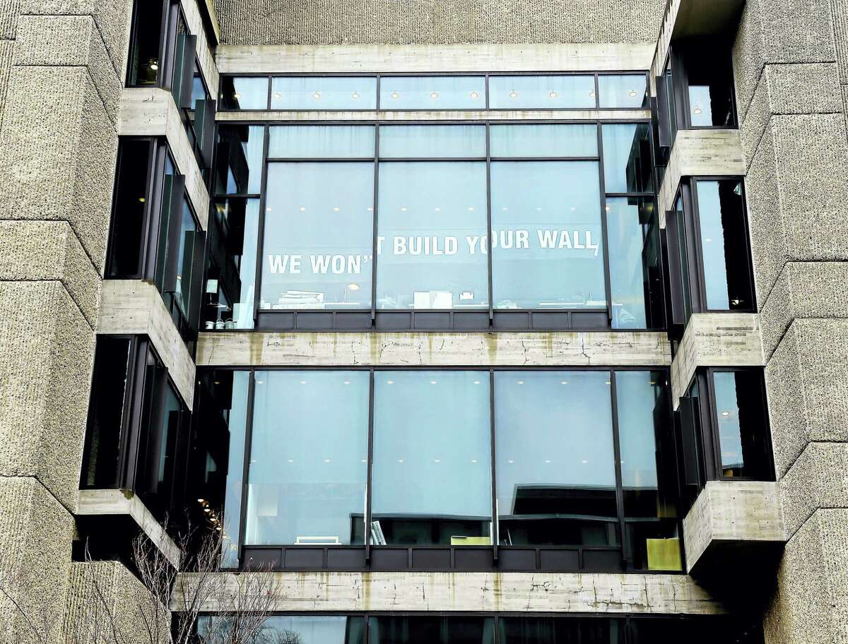 In one example of how area residents are letting their feelings be known since the election, a sign in protest to President Donald Trump’s plans for a wall on the border of the United States and Mexico was placed at Yale University’s Art and Architecture Building.