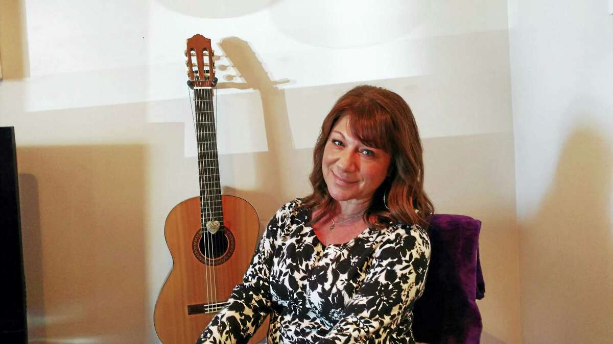 Donna Cimarelli, mother of slain high school student Maren Sanchez, is seated in front of Maren’s guitar.