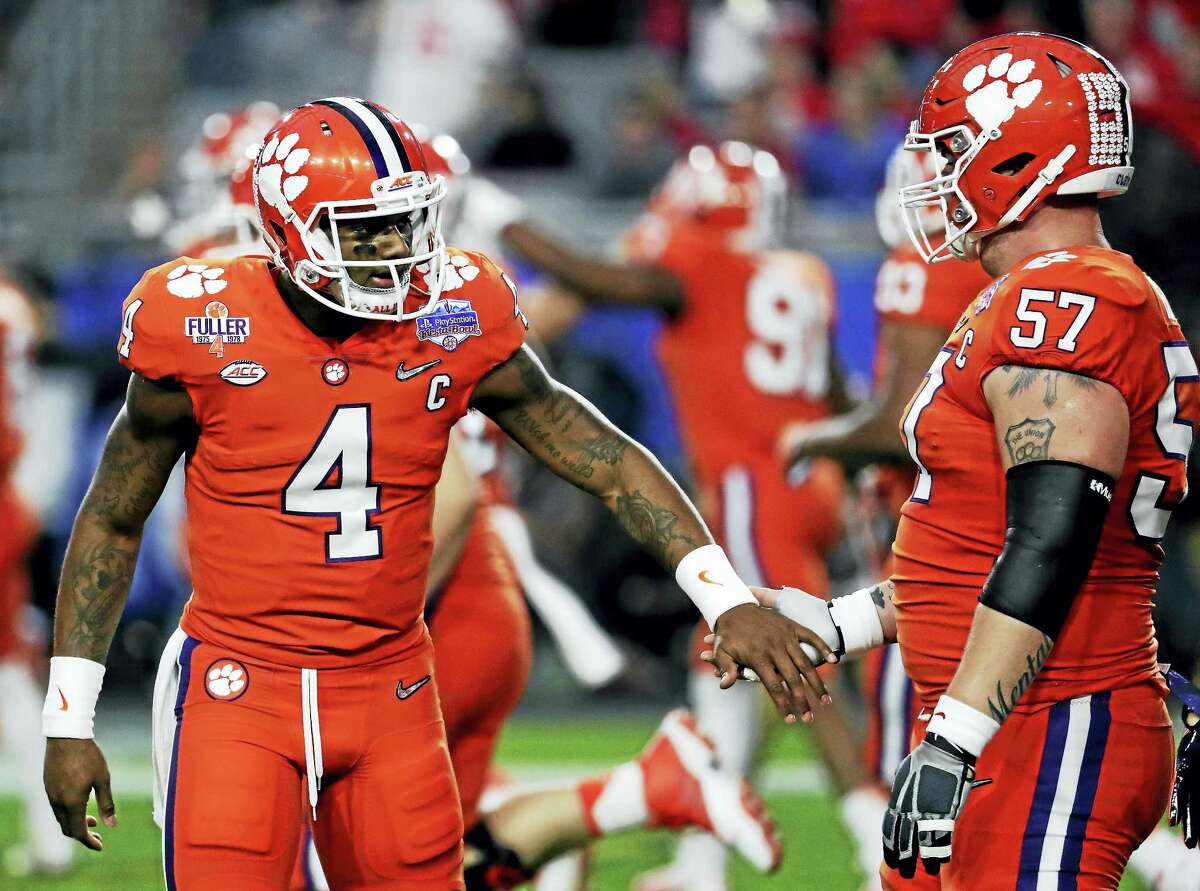 The Associated Press file photo Clemson quarterback Deshaun Watson (4) and Jay Guillermo (57) congratulate each other during the Fiesta Bowl.