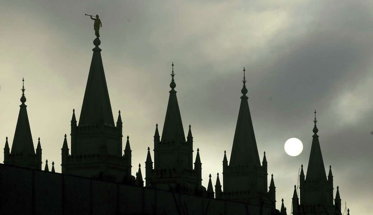 In this Feb. 6, 2013, file photo, the angel Moroni statue, silhouetted against a cloud-covered sky, sits atop the Salt Lake Temple, at Temple Square, in Salt Lake City. President Donald Trump’s executive order temporarily banning refugees and nearly all travelers from seven Muslim-majority countries is raising concerns from the Mormon church, Gov. Gary Herbert and by hundreds of protesters marking the latest illustration of Utah’s frosty relationship with Trump even though he carried the state.