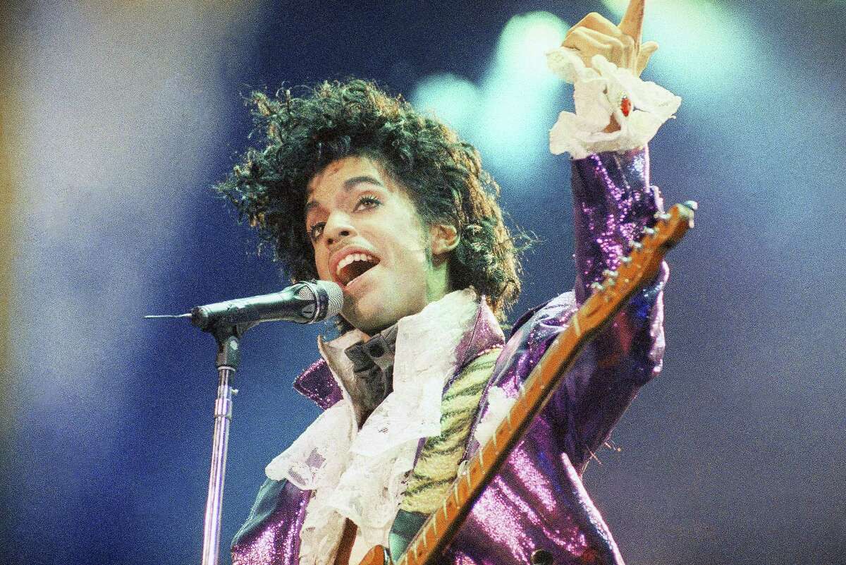 In this Feb. 18, 1985 photo, Prince performs at the Forum in Inglewood, Calif. A year after Prince died of an accidental drug overdose, his Paisley Park studio complex and home is now a museum and concert venue. Fans can now stream most of his classic albums, and a remastered “Purple Rain” album is due out in June 2017 along with two albums of unreleased music and two concert films from his vault.