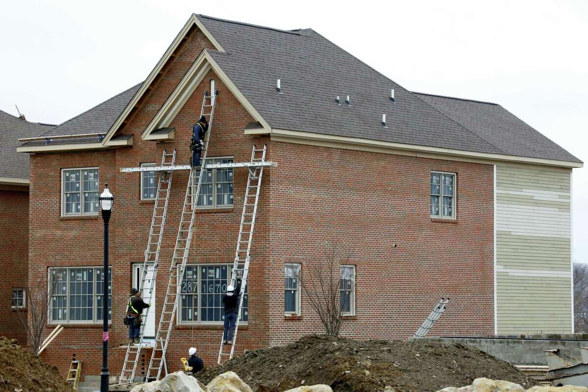 In this Jan. 18, 2017 photo, work continues on a new home under construction in Pittsburgh. U.S. homebuilders are feeling slightly less optimistic about their sales prospects, even as their overall outlook remains favorable. The National Association of Home Builders/Wells Fargo builder sentiment index released Monday, April 17, 2017 slipped to 68 for the month. That’s down three points from 71 in March, when it jumped to the highest level since June 2005.