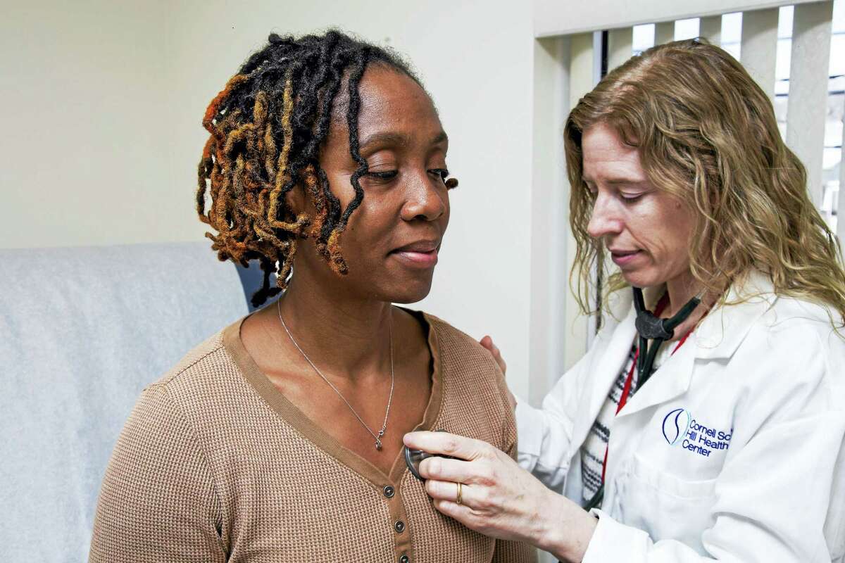 Natalie Lourenco, Physician Assistant, listens to Latoya Armstrong's heartbeat at Cornell Scott Hill Health Center in New Haven.Derek Torrellas - Conn. Health I-Team