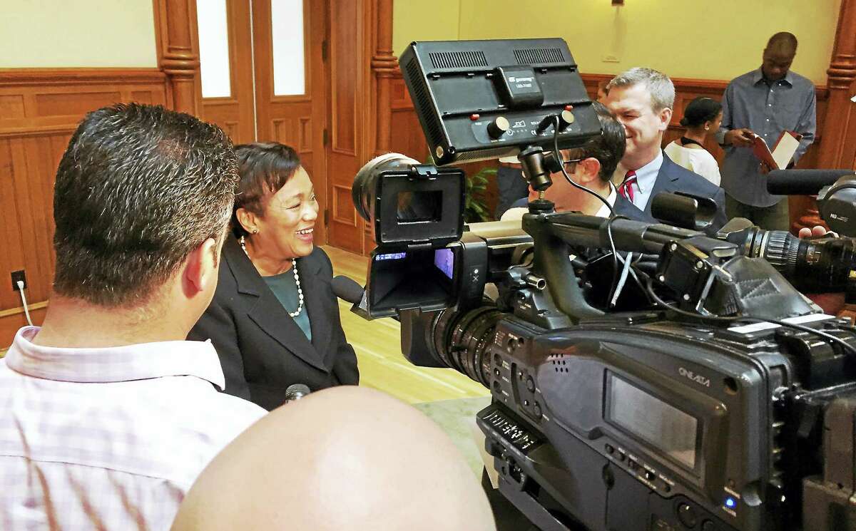 Mayor Toni Harp shares a light moment with TV journalists at City Hall during the summer preview Tuesday.
