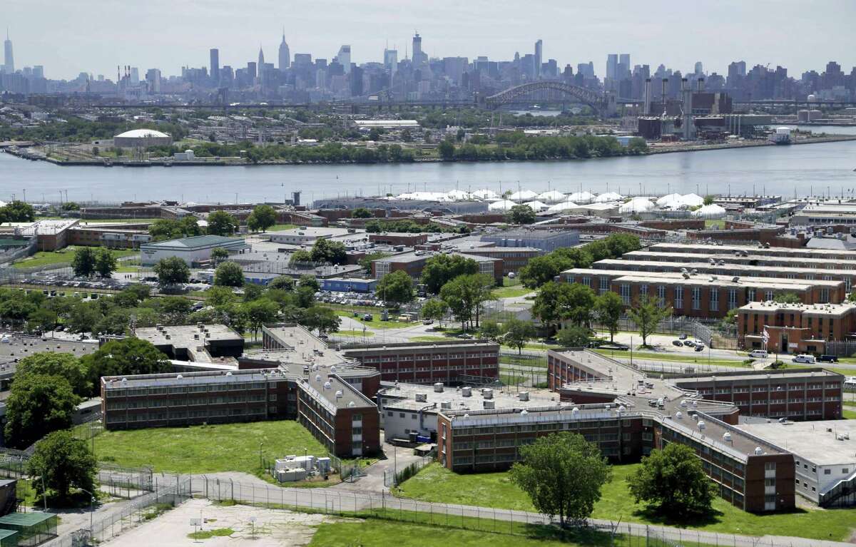 In this this file photo, the Rikers Island jail complex stands in the foreground with the New York skyline in the background. Inmate activists, for more than a year, have argued that shutting down the sprawling, 10-jail complex in the East River is the only solution for a cycle of abuses that include violence by guards and gang members, mistreatment of the mentally ill and juveniles, and unjustly long detention for minor offenders.