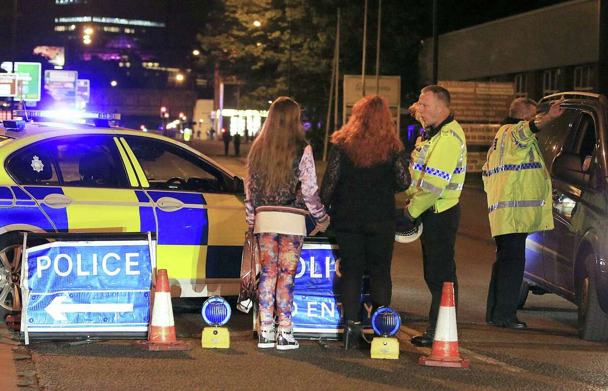 Police work at Manchester Arena after reports of an explosion at the venue during an Ariana Grande gig in Manchester, England Monday, May 22, 2017. Several people have died following reports of an explosion Monday night at an Ariana Grande concert in northern England, police said. A representative said the singer was not injured.
