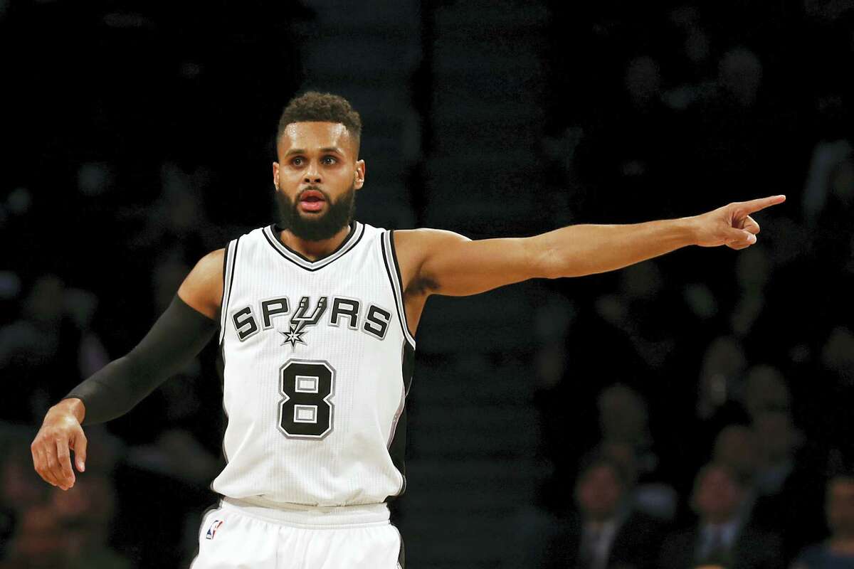 In this Monday, Jan. 23, 2017 photo, San Antonio Spurs guard Patty Mills (8) gestures after making a three point basket during the second half of an NBA basketball game against the Brooklyn Nets, in New York. Teams, and the league, try to make the transition to the NBA easier for all players, but internationals need some special attention. “You’re in South Texas and it’s very different from Australia,” Mills said.