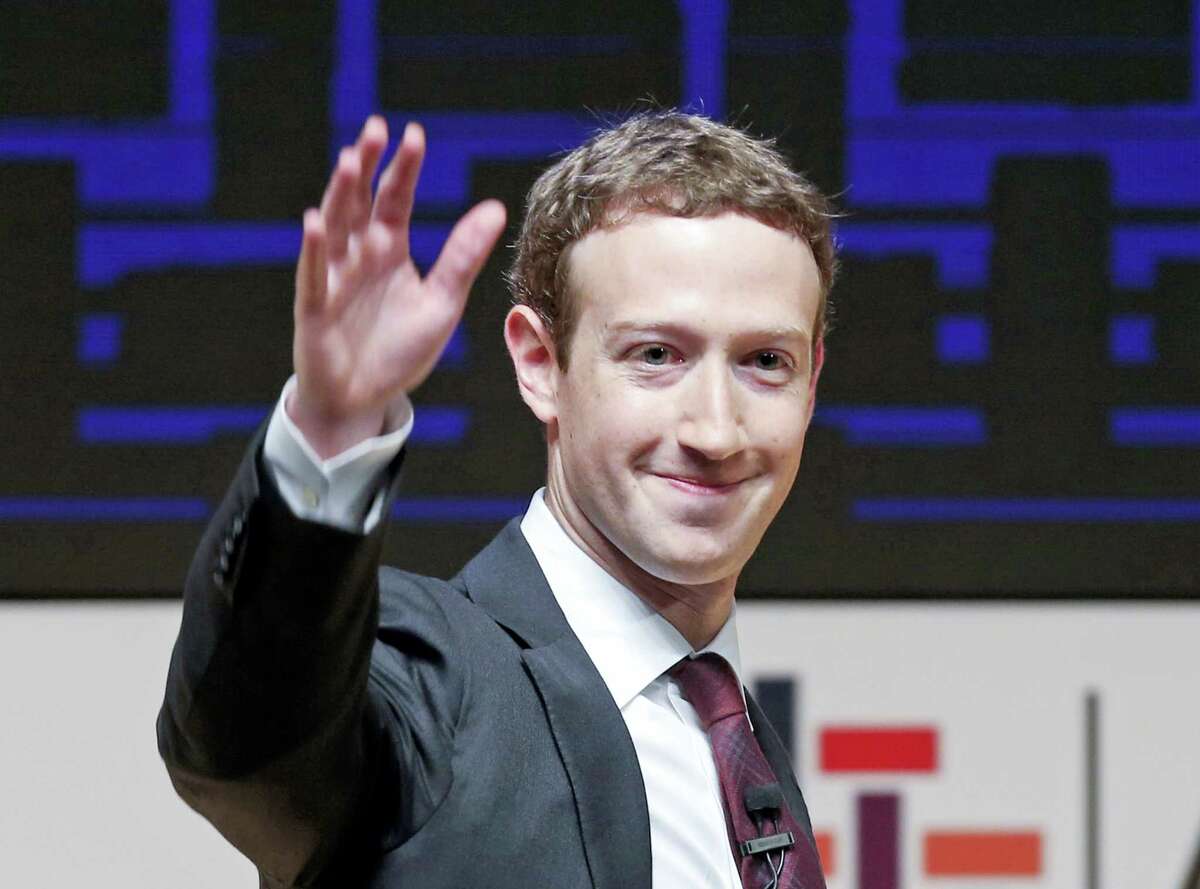 In this Nov. 19, 2016 photo, Mark Zuckerberg, chairman and CEO of Facebook, waves at the CEO summit during the annual Asia Pacific Economic Cooperation (APEC) forum in Lima, Peru. Zuckerberg released a missive Thursday, Feb. 16, 2017, outlining his vision for the social network and the world at large. Among other things, Zuckerberg hopes that the social network can encourage more civic engagement, an informed public and community support in the years to come.