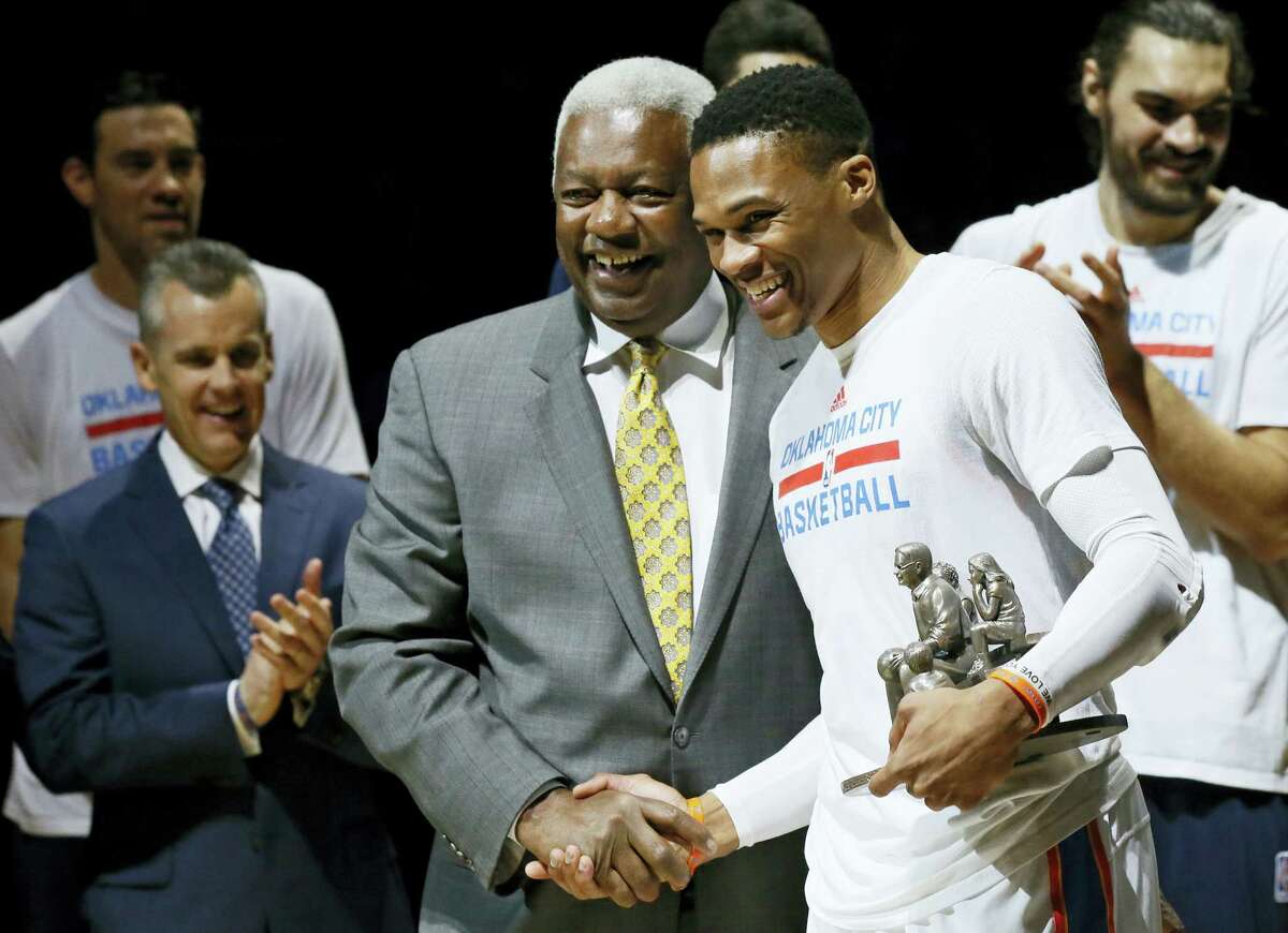 Oklahoma City Thunder guard Russell Westbrook, right, is congratulated by Oscar Robertson on his triple-double record before the Thunder’s game on Wednesday.