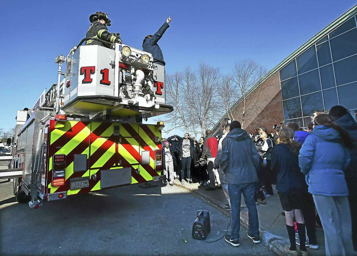 Tricia Fabbri, the head coach for the Quinnipiac women’s basketball team speaks from a Hamden fire truck at the Sweet 16 Send-Off Rally for the Bobcats at the TD Bank Sports Center at the York Hill Campus in Hamden, Wednesday.