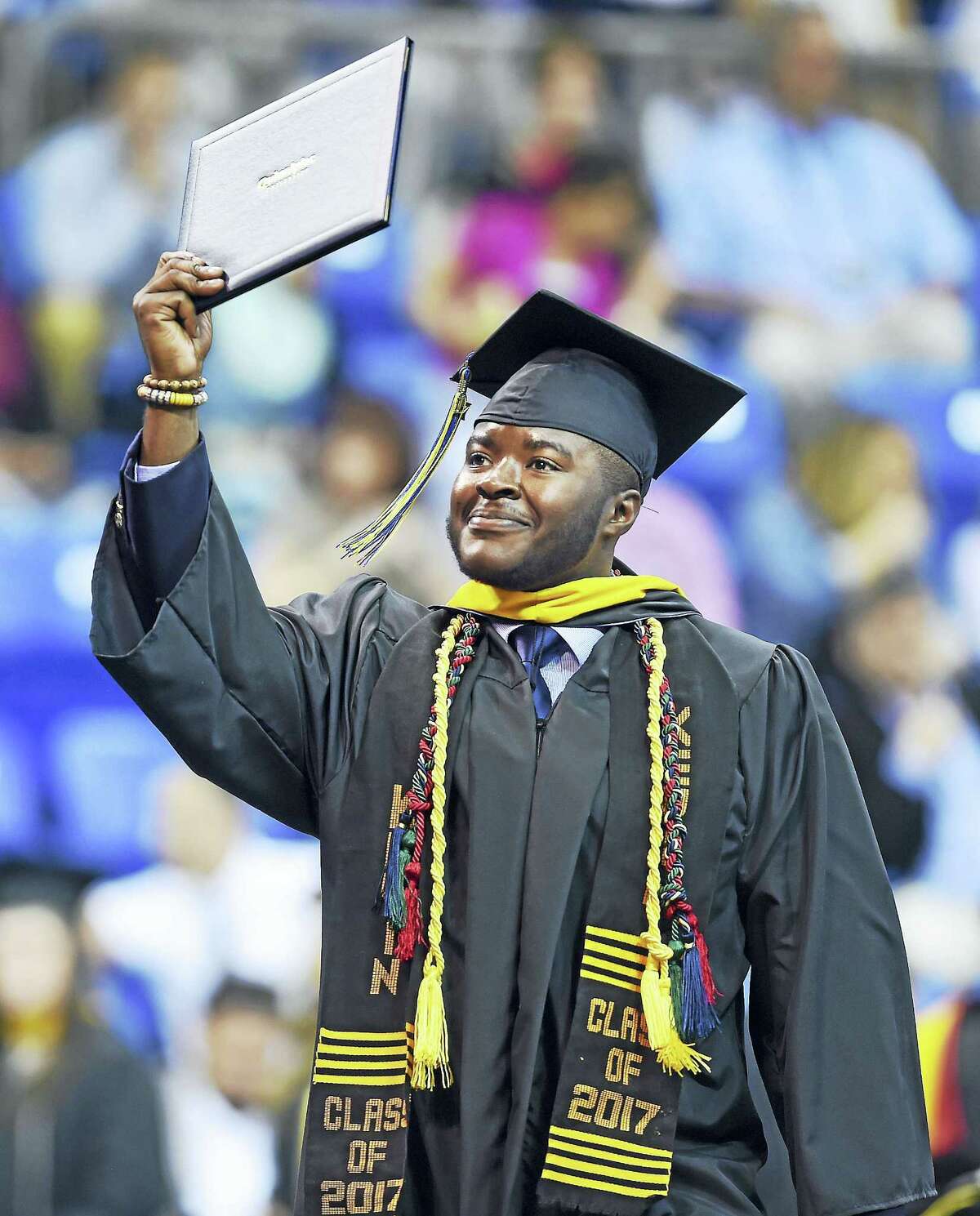 Kevin Otchere shows off his diploma at commencement exercises for Quinnipiac University’s College of Arts and Sciences at the TD Bank Sports Center in Hamden on 5/20/2017. Otchere graduated Magna Cum Laude with a Bachelor of Science degree.