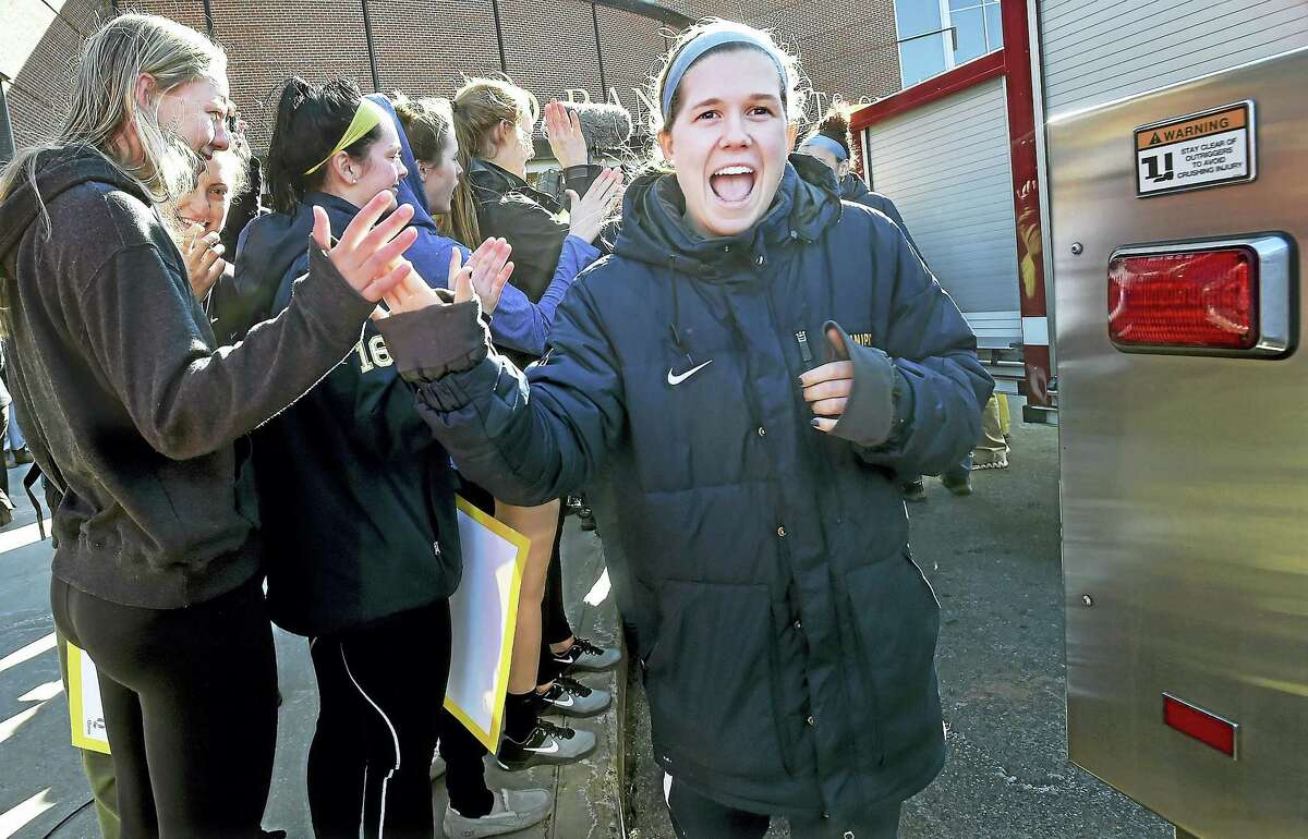 Quinnipiac guard Carly Fabbri walks through giving high fives to fans as the women’s basketball team attends a Sweet 16 Send-Off Rally at the TD Bank Sports Center.