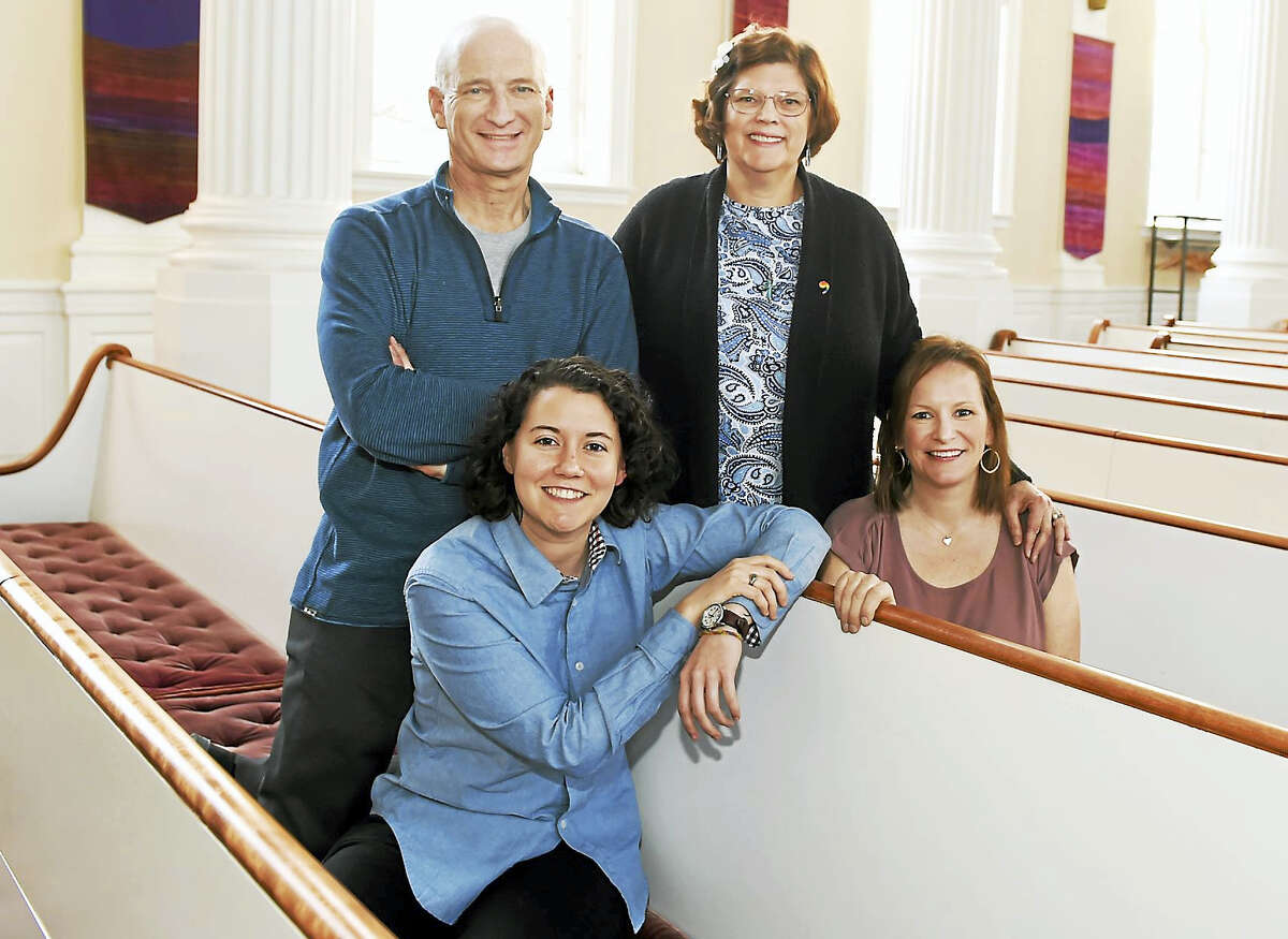 Standing, left to right: Tony Forman of the Church of the Redeemer and Kathryn Thomas of the United Church on the Green. Sitting, left to right: Caryne Eskridge of United and Beth Pellegrino of Redeemer. They were photographed in the sanctuary at the Church of the Redeemer in New Haven.