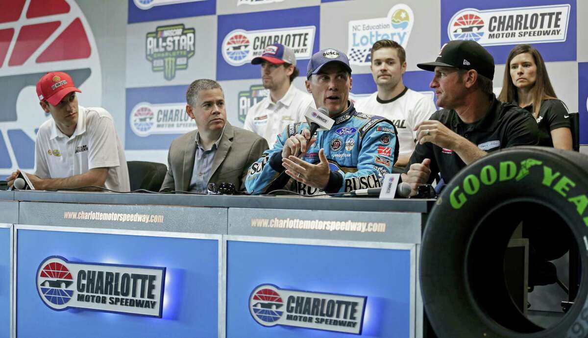 John Entz, FOX Sports President & Executive Producer, Production, second from left, listens during a news conference with NASCAR drivers at Charlotte Motor Speedway in Concord, N.C.
