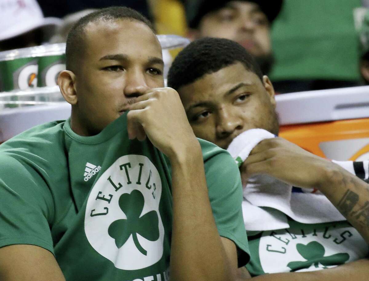 Celtics guards Avery Bradley, left, and Marcus Smart watch from the bench on Friday.