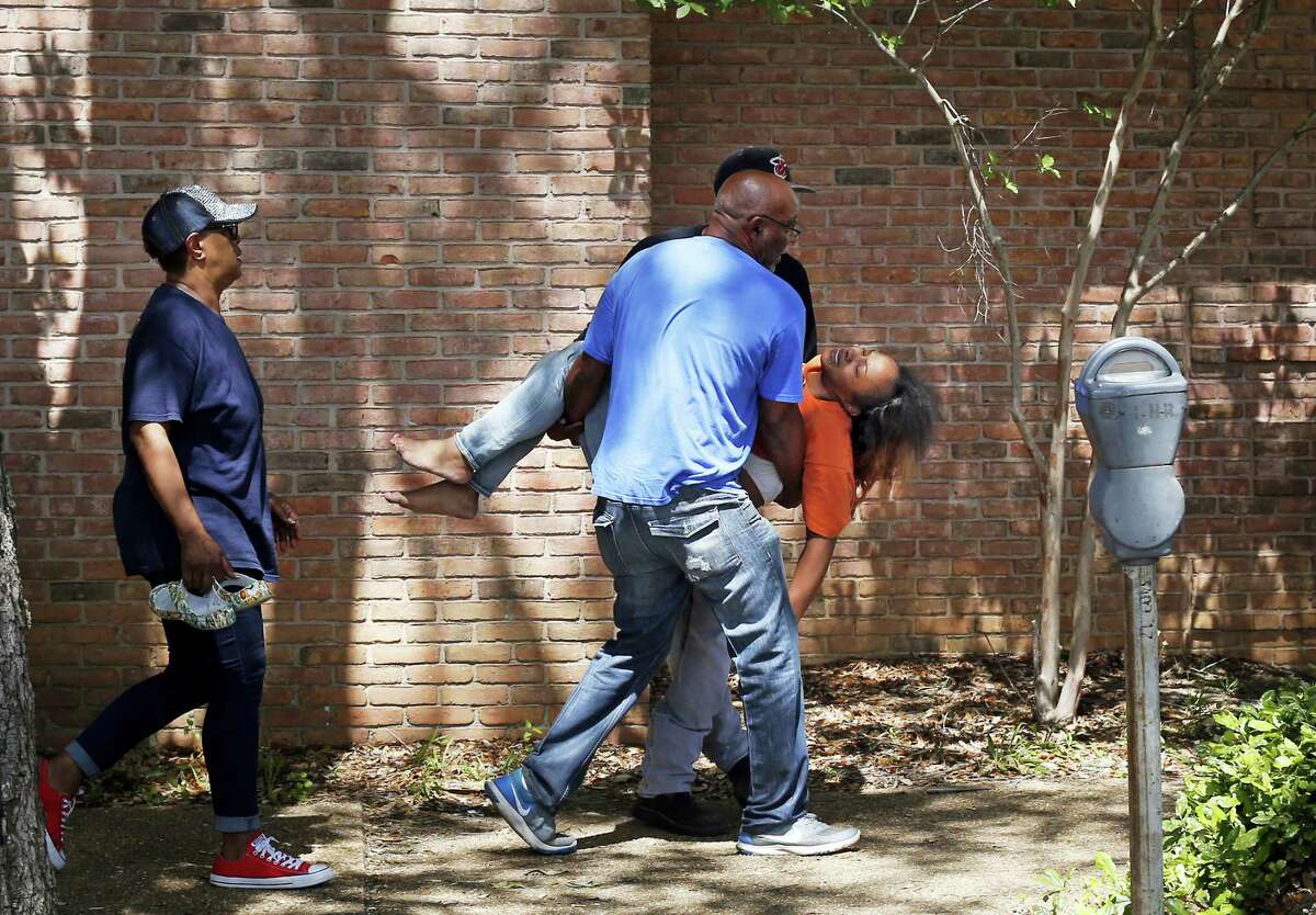 Family members carry a grief stricken Ebony Archie, mother of Kingston Frazier, after learning the young boy was found dead after being kidnapped during the theft of his mother’s vehicle from a Kroger parking lot, Thursday, May 18, 2017, in Jackson, Miss.