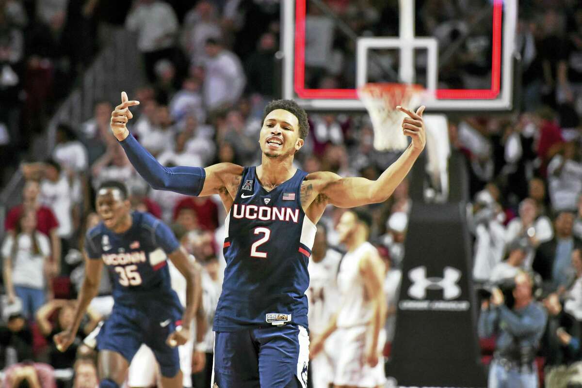 UConn’s Jalen Adams gestures to the crowd after hitting the game-winning shot against Temple on Sunday.