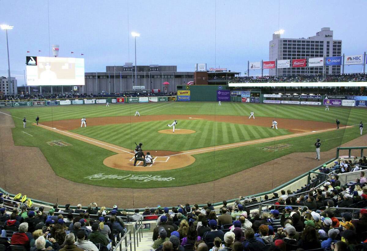 Hartford Yard Goats pitcher Yency Almonte throws the first official pitch at Hartford's new Dunkin' Donuts Park on opening day in Hartford, Conn., Thursday, April 13, 2017. The city and its minor league baseball team are celebrating opening day at the city‚Äôs new 6,000-seat stadium, a year late and millions of dollars over budget. (AP Photo/Pat Eaton-Robb)