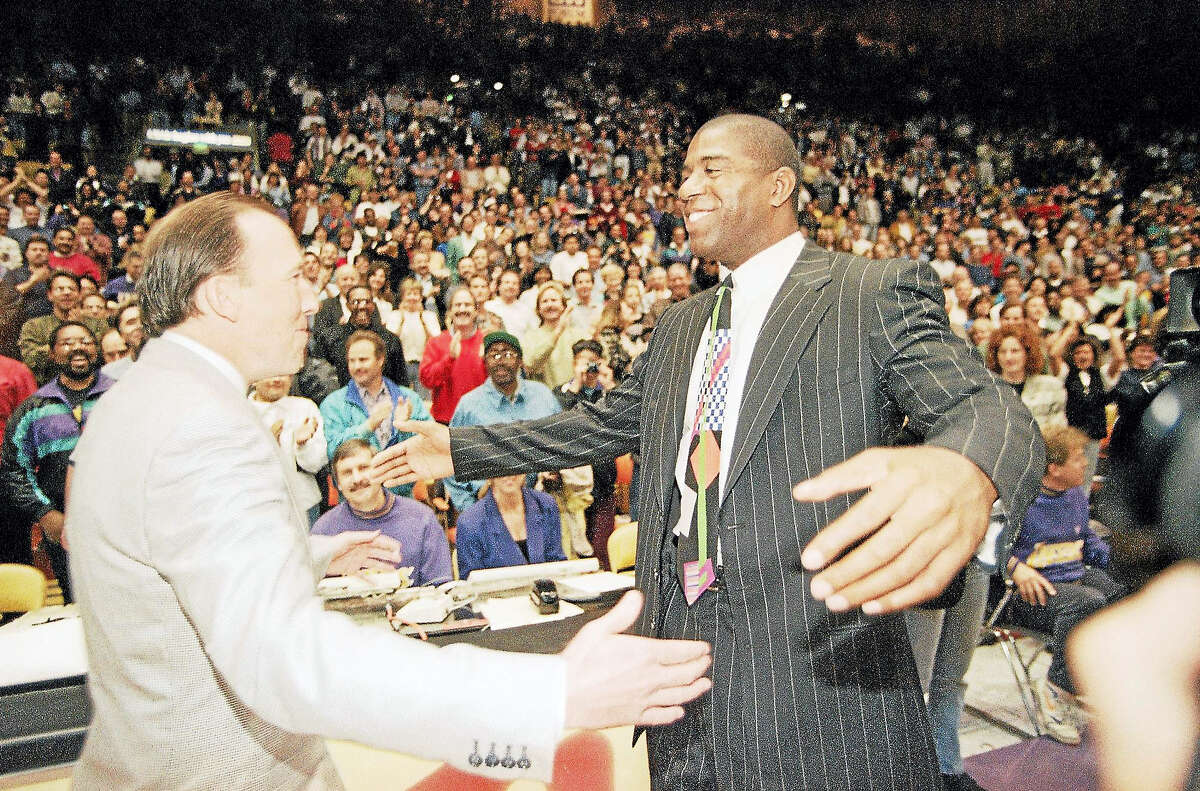 Magic Johnson, during his brief stint as Lakers coach, greets his former coach Mike Dunleavy Sr., who was coaching the Bucks in 1994.