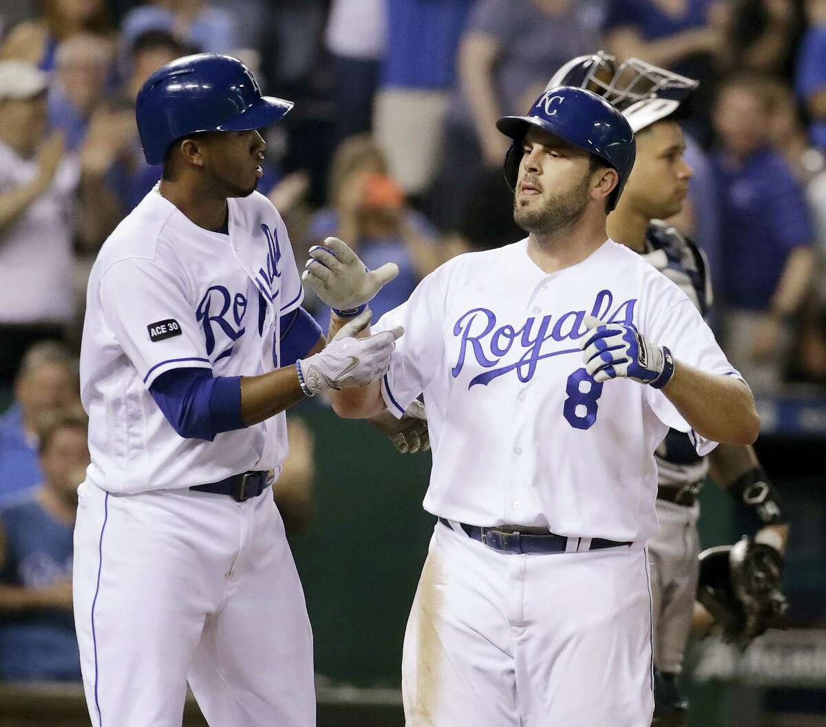 The Royals’ Mike Moustakas (8) celebrates with Alcides Escobar after hitting a three-run home run in the fifth inning Thursday.