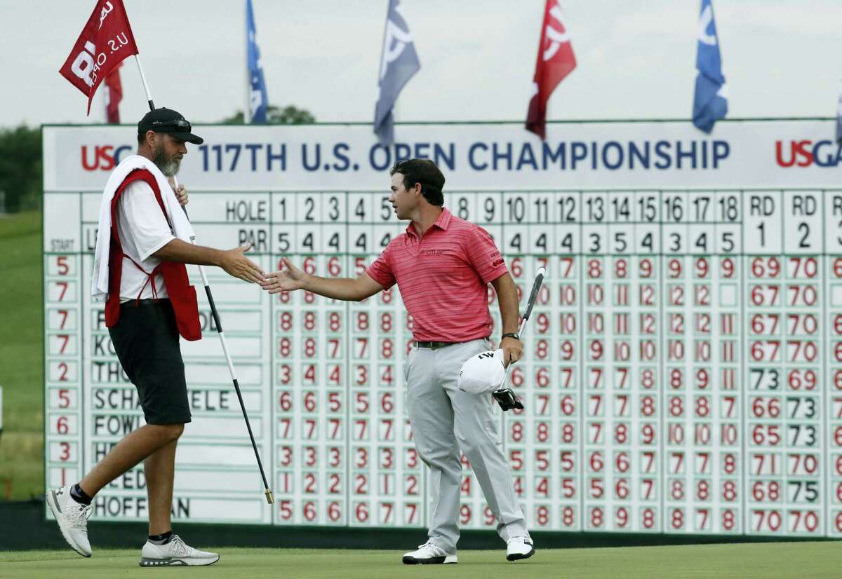 Brian Harman shakes hands with his caddie after the third round.