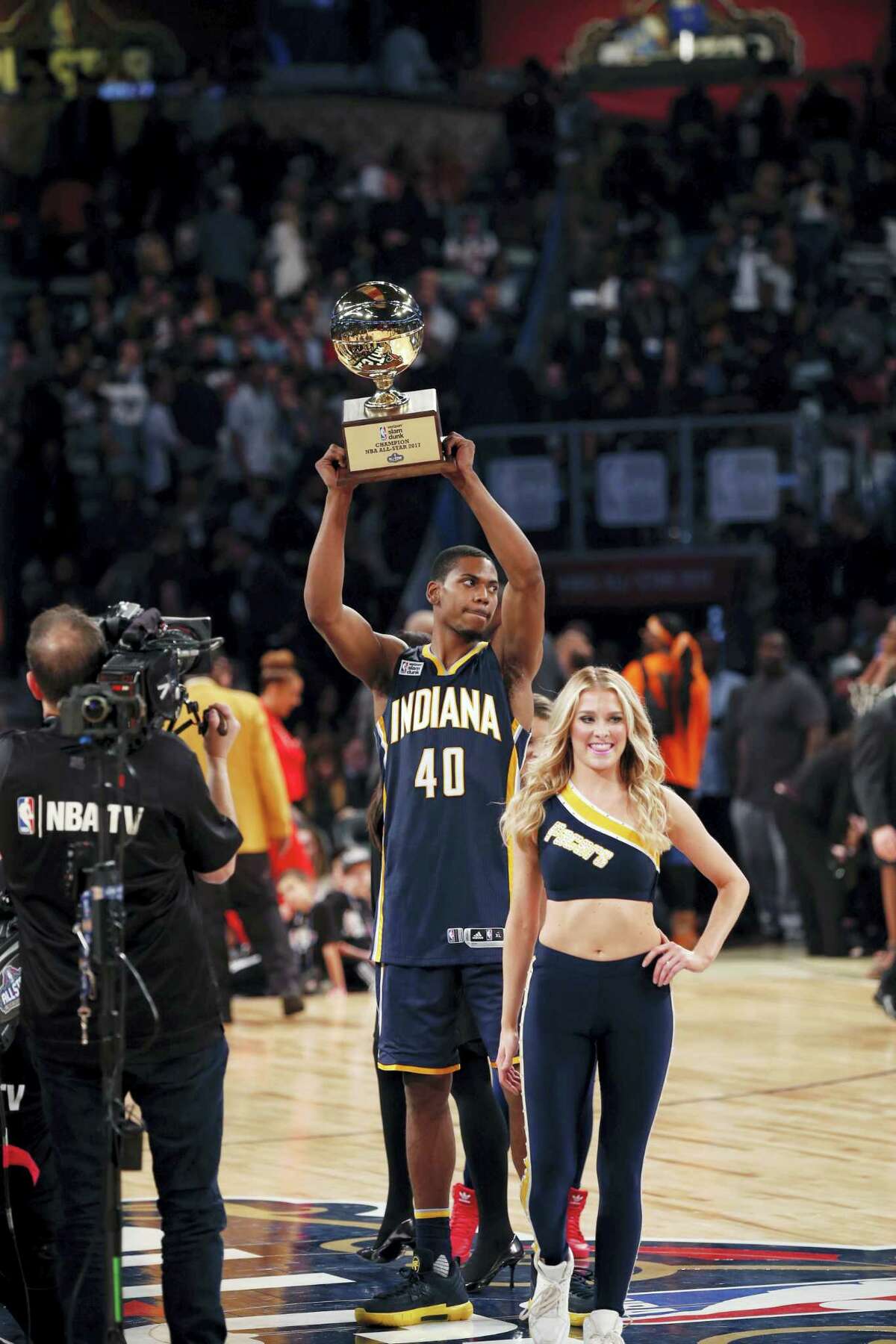 Indiana pacers Glenn Robinson III holds up his trophy after winning the slam dunk contest during NBA All-Star Saturday Night events in New Orleans, Saturday, Feb. 18, 2017. (AP Photo/Gerald Herbert)