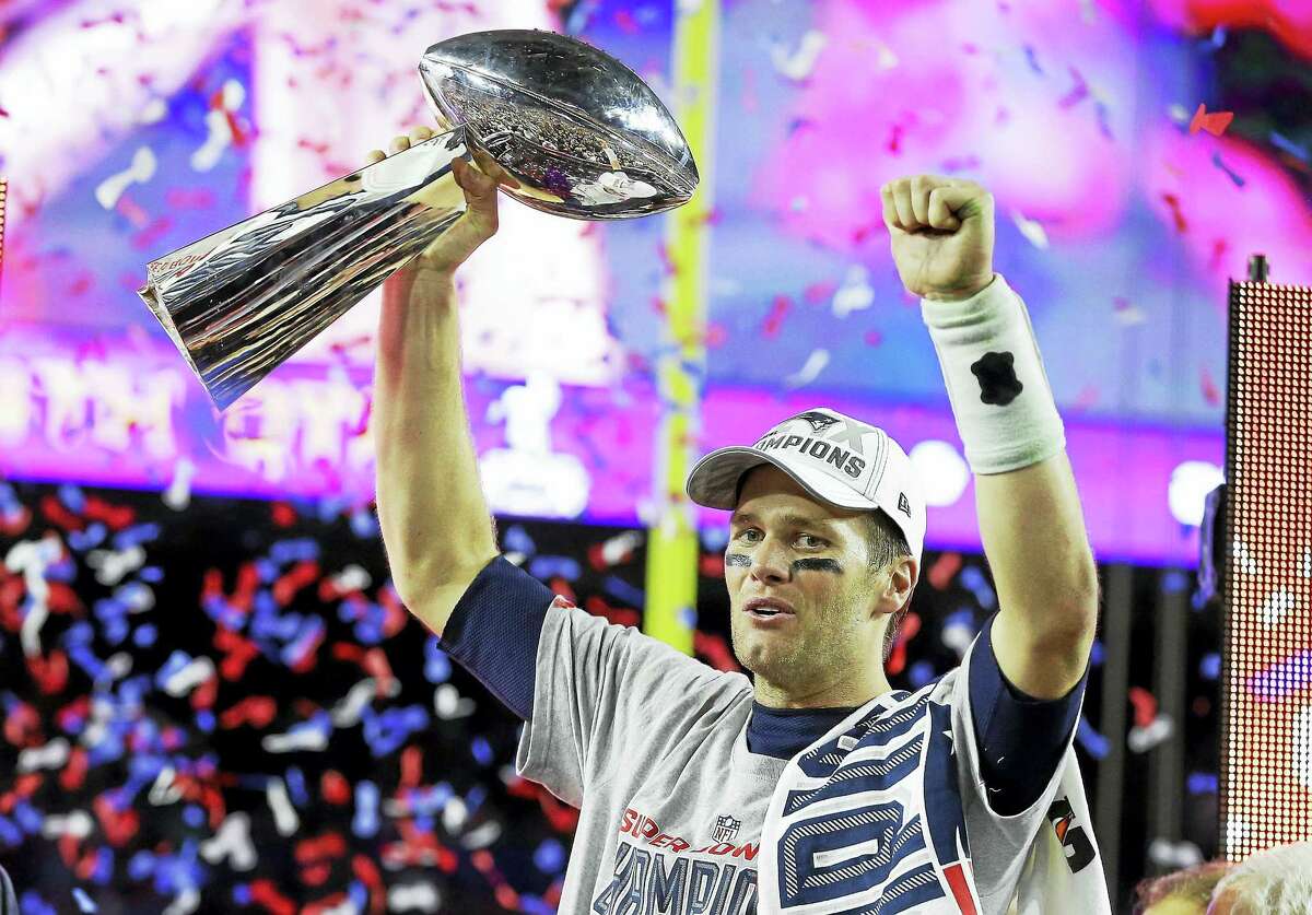 Patriots quarterback Tom Brady celebrates with the Vince Lombardi Trophy after winning Super Bowl XLIX against the Seattle Seahawks.