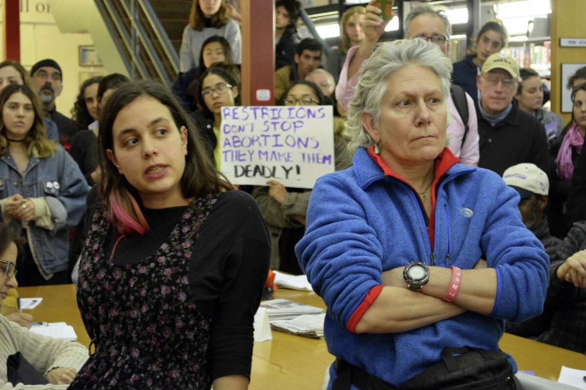 “Restrictions don’t stop abortions. They make them deadly,” read one of the signs held up by the more than 300 people who attended Sen. Len Suzio’s town hall meeting at the Russell Library to talk about the upcoming Legislative session.