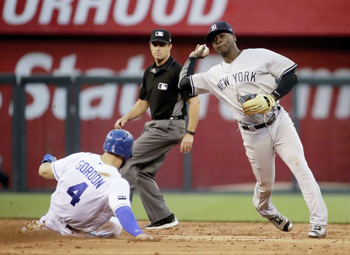 New York Yankees shortstop Didi Gregorius throws to first for the double play after forcing Alex Gordon out a second during the third inning Wednesday. The Yankees won 11-7.