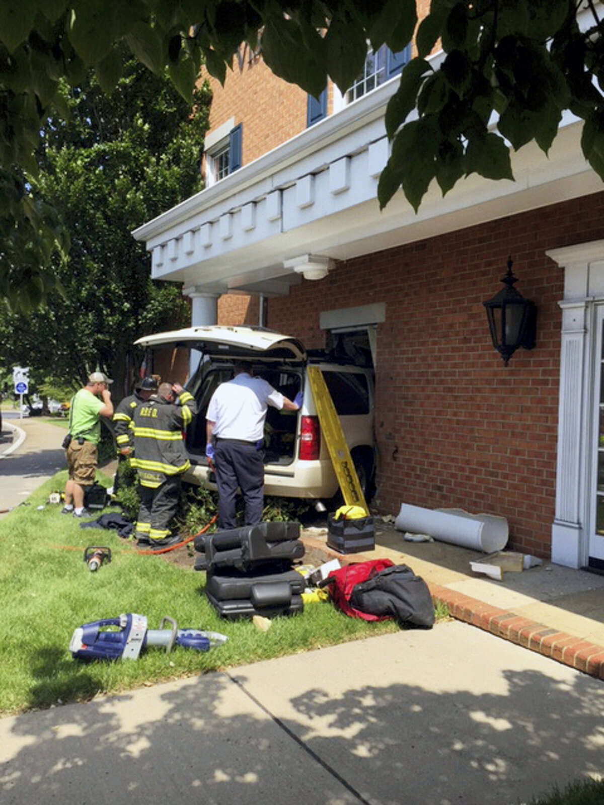 First responders work at the scene of an automobile accident in Red Bank, N.J. Former Red Sox and Mets infielder John Valentin and his mother were injured when the SUV he was driving crashed into the building used by Visiting Nurse Association.