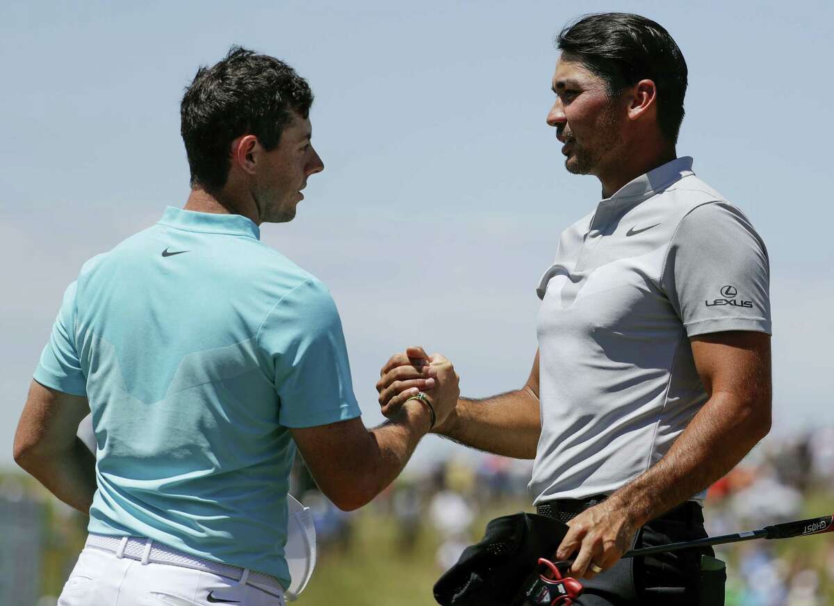 Jason Day, right, and Rory McIlroy shake hands after the second round of the U.S. Open. Both are committed to play in next week’s Travelers Championship in Cromwell.