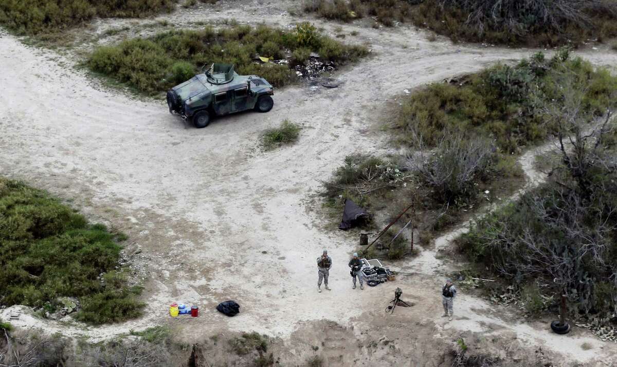 In this file photo, members of the National Guard patrol along the Rio Grande at the Texas-Mexico border in Rio Grande City, Texas. The Trump administration is considering a proposal to mobilize as many as 100,000 National Guard troops to round up unauthorized immigrants, including millions living nowhere near the Mexico border, according to a draft memo obtained by The Associated Press.