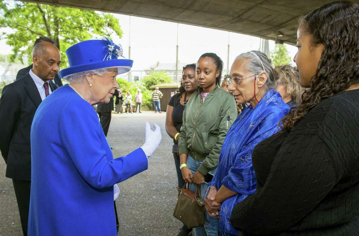 Queen Elizabeth II meets members of the community affected by the fire at Grenfell Tower during a visit to the Westway Sports Centre which is providing temporary shelter for those who have been made homeless by the fire at Grenfell Tower, in London, Friday June 16, 2017. Relatives of those missing after a high-rise tower blaze in London are searching frantically for their loved ones, as the police commander in charge of the investigation says he hopes the death toll will not rise to three figures.