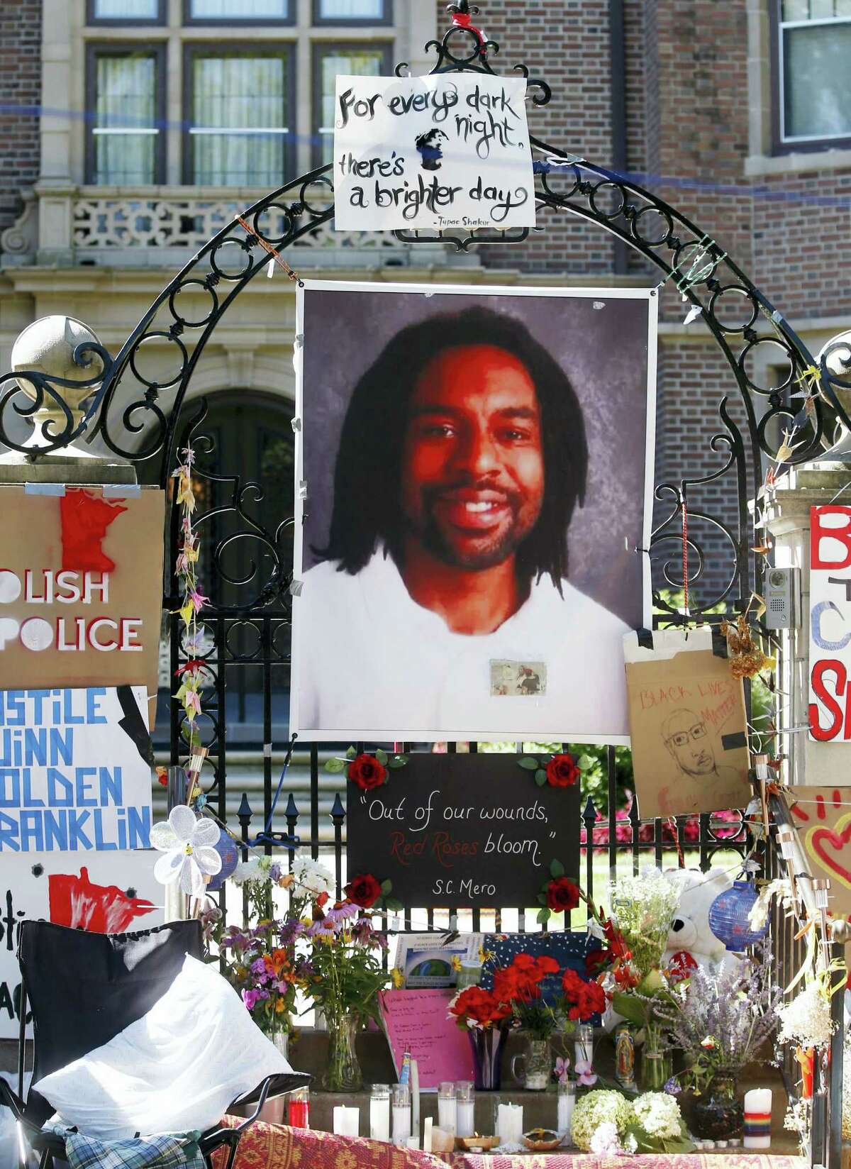 FILE - In this July 25, 2016, file photo, a memorial including a photo of Philando Castile adorns the gate to the governor’s residence in St. Paul, Minn., protesting the July 6, 2016 shooting death of Castile by St. Anthony police officer Jeronimo Yanez. Closing arguments began Monday, June 12, 2017 in in a Yanez’ manslaughter trial in the fatal shooting of Castile.