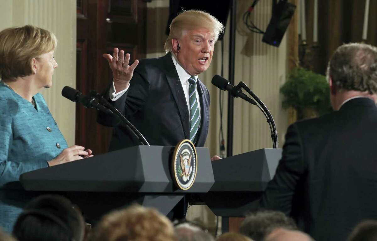 President Donald Trump, joined by German Chancellor Angela Merkel, left, speaks during a joint news conference in the East Room of the White House in Washington, Friday.