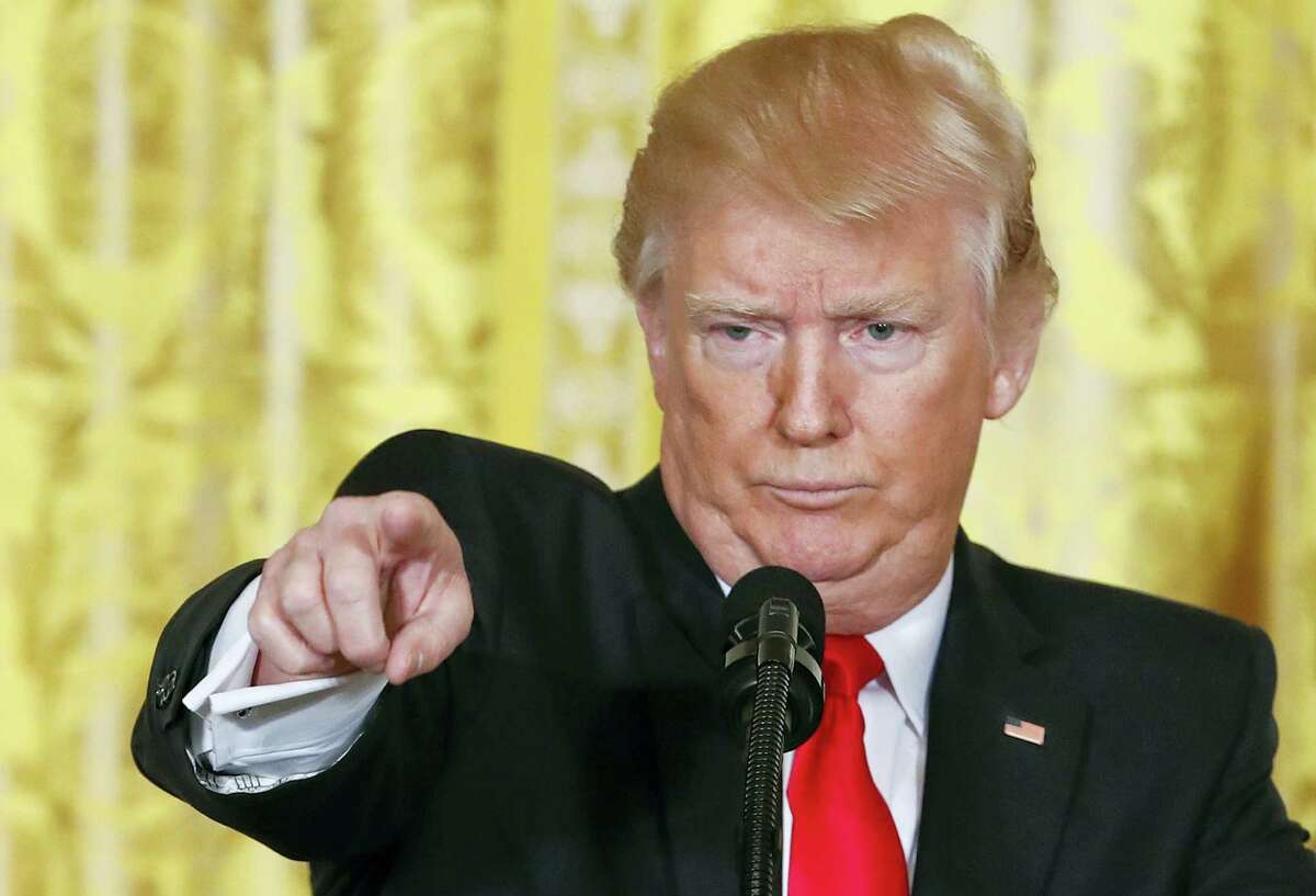 President Donald Trump points to a member of the media as he takes questions during a news conference in the East Room of the White House in Washington, Thursday, Feb. 16, 2017.