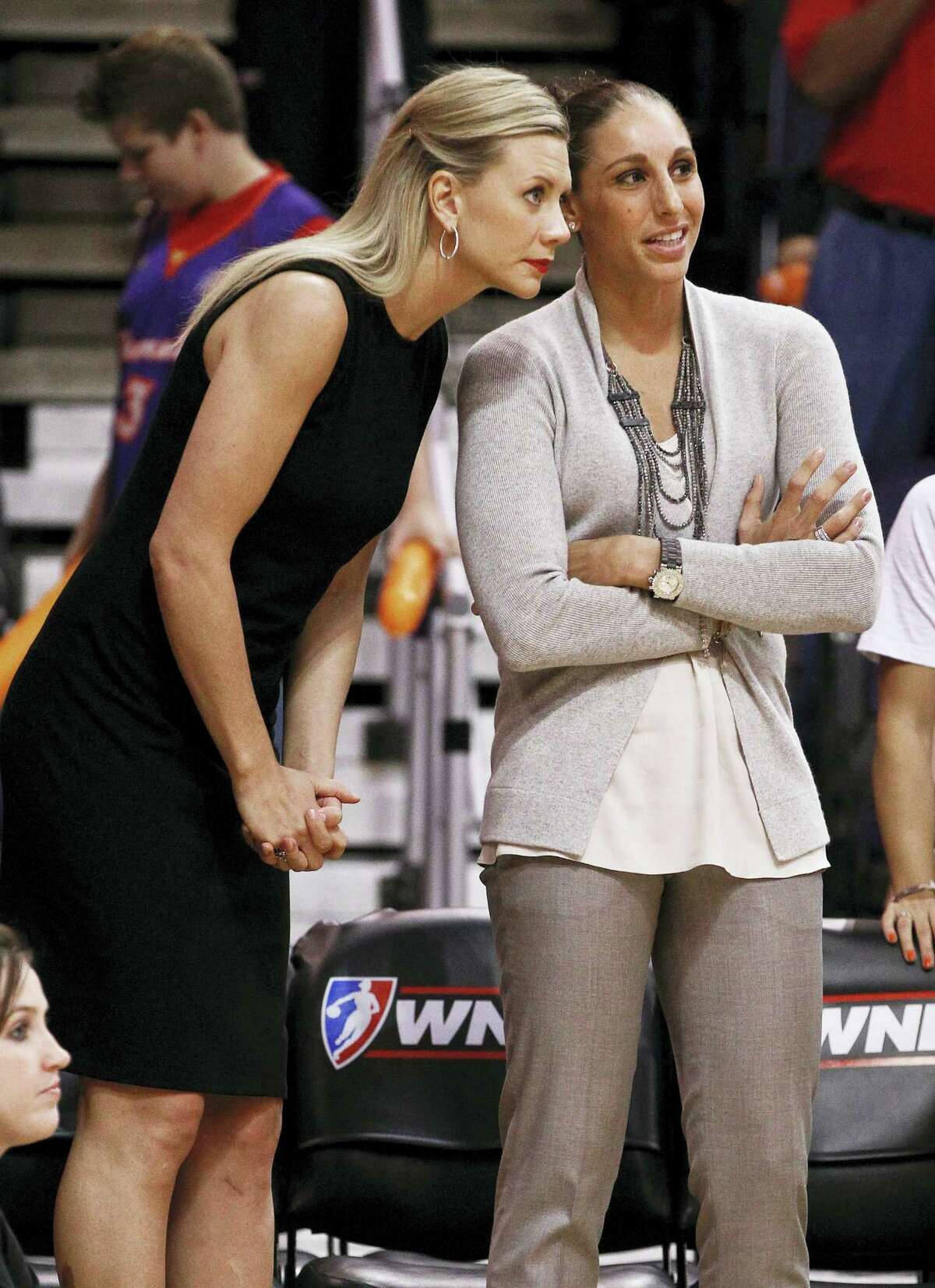 In this Sept. 12, 2012 photo, injured Phoenix Mercury players Penny Taylor, left, of Australia, and Diana Taurasi stand at the team bench during the first half of a WNBA basketball game against the Connecticut Sun, in Phoenix. Diana Taurasi has married former Phoenix Mercury teammate Penny Taylor, then played in the team’s season opener less than 24 hours later. The 34-year-old Taurasi has played for the Mercury since 2004, helping the team win three titles. She also helped the U.S. win four consecutive Olympic gold medals. The couple married May 13, 2017.