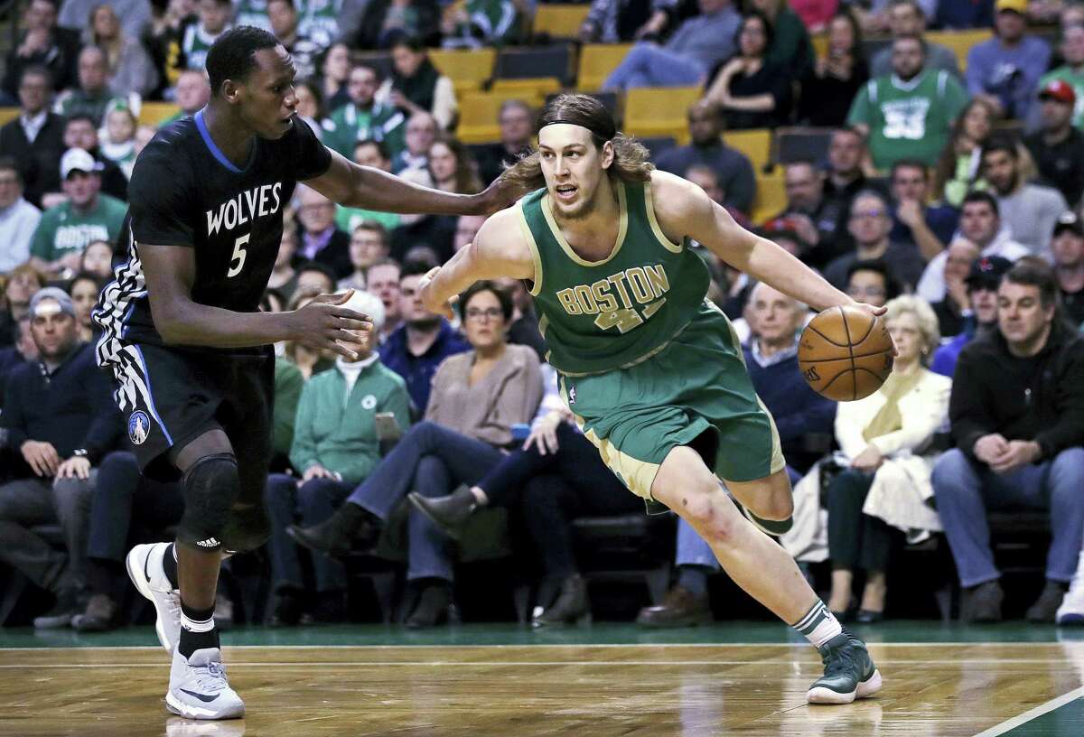 Boston Celtics center Kelly Olynyk (41) drives to the basket against Minnesota Timberwolves forward Gorgui Dieng (5) during the first quarter of an NBA game in Boston, Wednesday, March 15, 2017. (AP Photo/Charles Krupa)