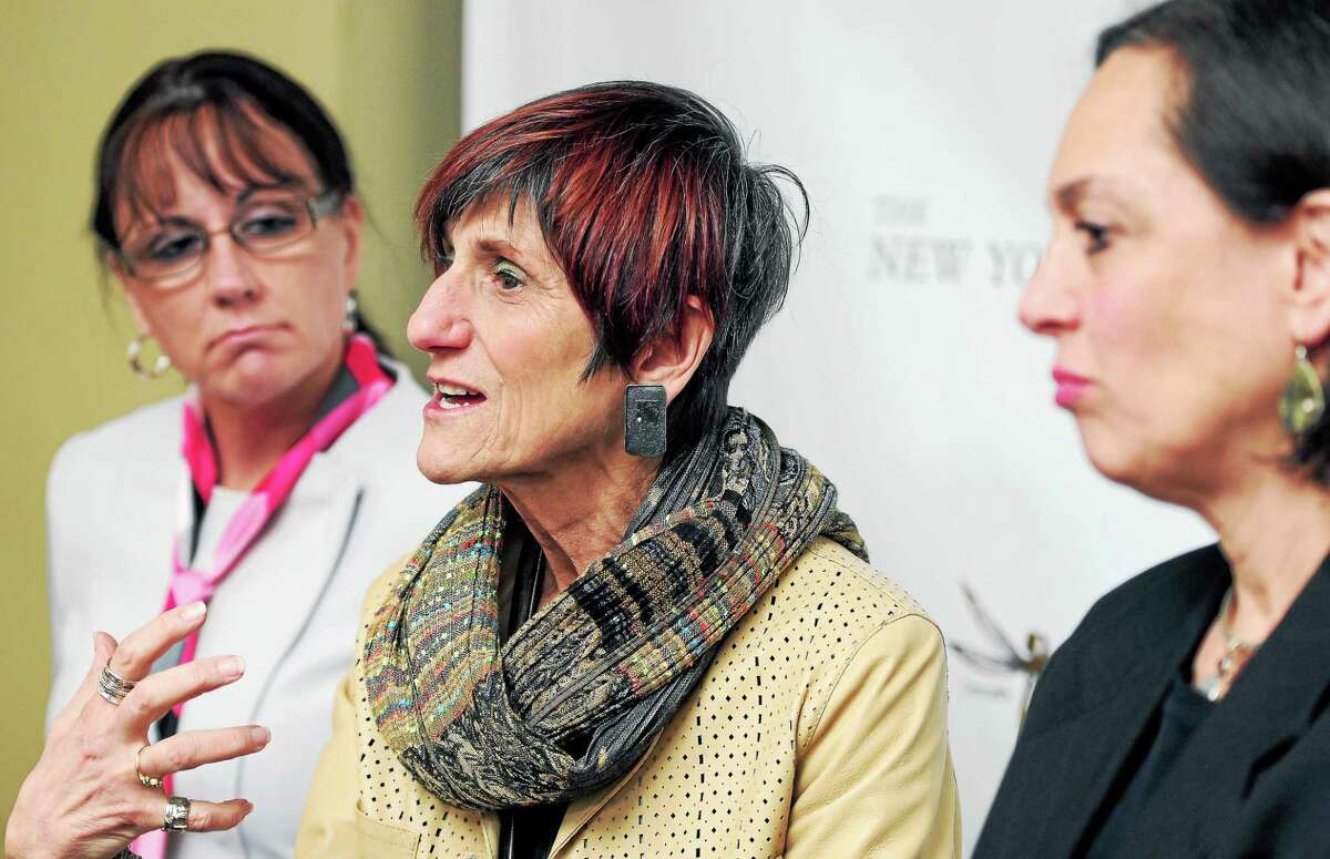 Tammy Sneed, left, director of Girls’ Services for the Connecticut Department of Children and Families, and DCF Commissioner Joette Katz, right, listen to U.S. Rep. Rosa DeLauro speak about the problem of sex trafficking in New Haven in 2014.