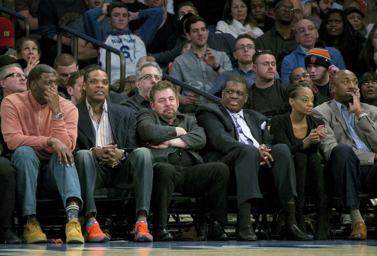 Madison Square Garden chairman James Dolan, center left, sits with former New York Knicks team members and others as he watched the Knicks take on the San Antonio Spurs during an NBA basketball game at Madison Square Garden in New York on Feb. 12, 2017.