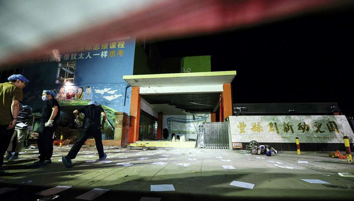 In this photo released by China’s Xinhua News Agency, investigators work early Friday, June 16, 2017, at the scene of an explosion outside a kindergarten in Fengxian County in eastern China’s Jiangsu Province. Several people were killed and dozens more injured in an explosion Thursday at the front gate of the kindergarten in eastern China as relatives were picking up their children at the end of the school day, local officials said.