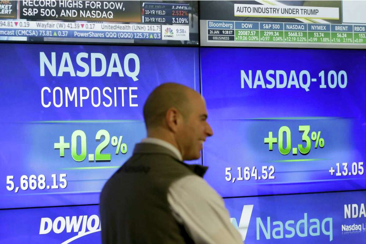 Screens for the Nasdaq Composite and Nasdaq-100 are displayed at Nasdaq, Thursday, Jan. 26, 2017, in New York.