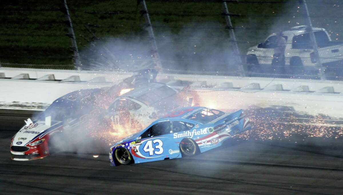 Aric Almirola (43) crashes into Danica Patrick (10) and Joey Logano (22) during the NASCAR Monster Cup auto race at Kansas Speedway in Kansas City, Kan. on May 13, 2017.