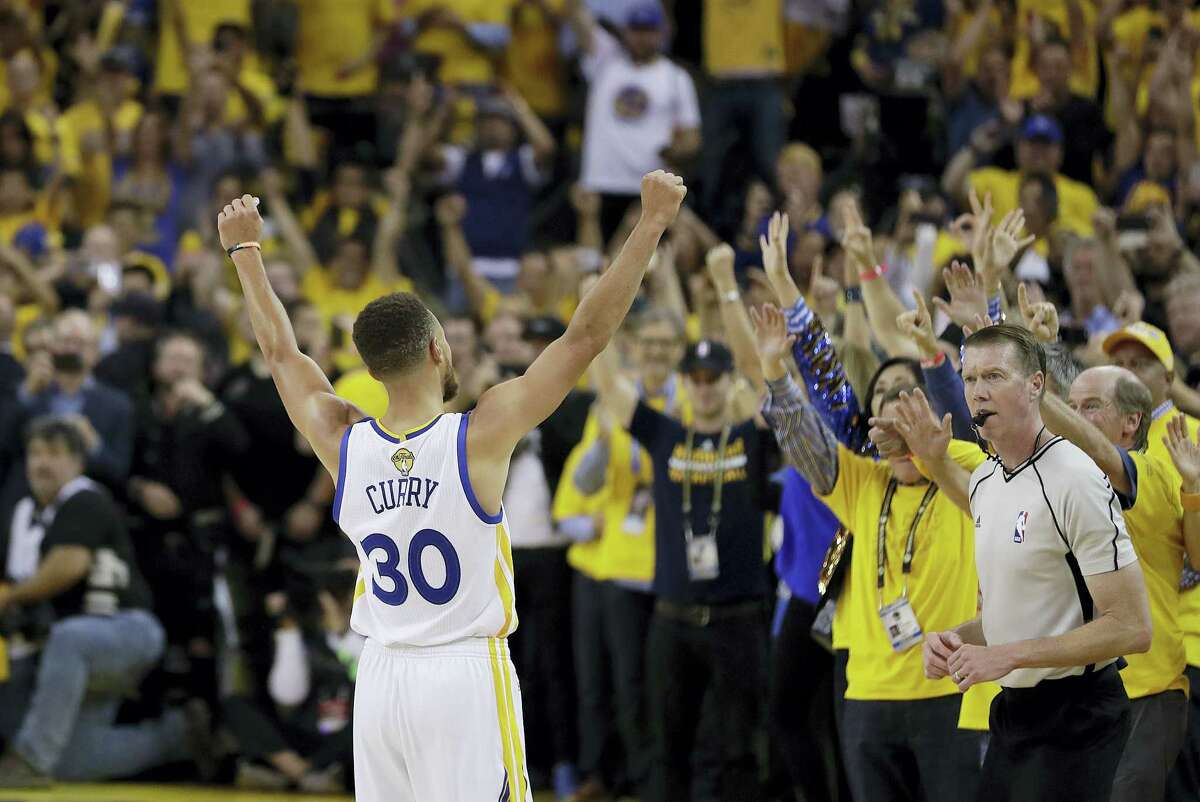 Golden State Warriors guard Stephen Curry (30) celebrates with fans after Game 5 of basketball’s NBA Finals between the Warriors and the Cleveland Cavaliers in Oakland, Calif., on Monday. The Warriors won 129-120 to win the NBA championship.