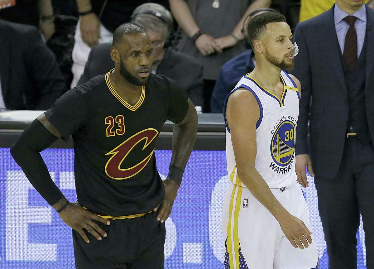 Cleveland Cavaliers forward LeBron James (23) and Golden State Warriors guard Stephen Curry (30) during the first half of Game 5 of basketball’s NBA Finals in Oakland, Calif., on Monday.