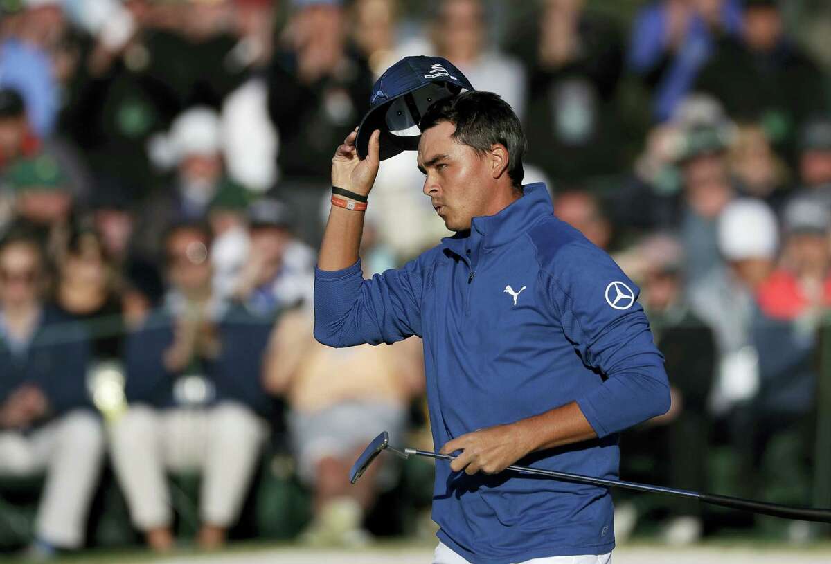 Rickie Fowler tips his hat on the 18th green during the second round of the Masters on Friday.