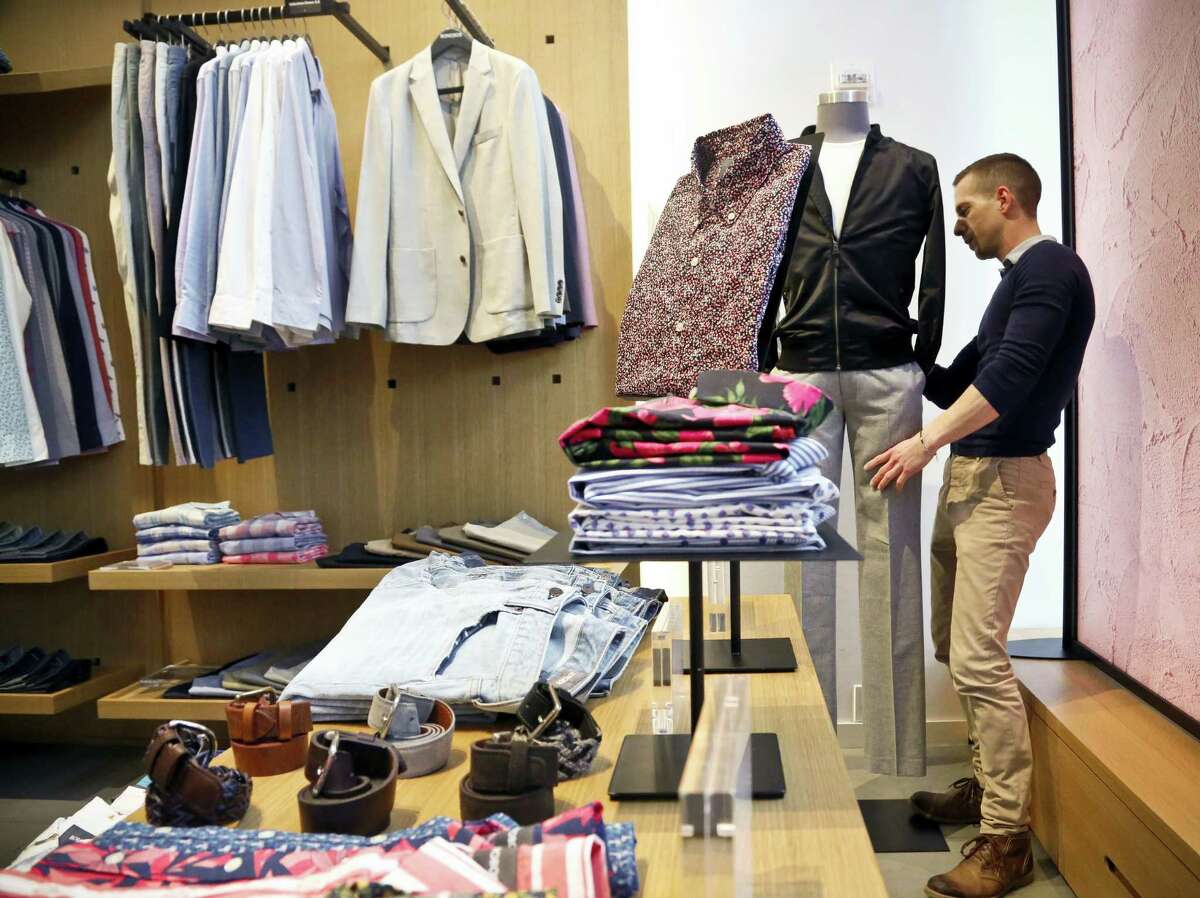 In this Monday, March 20, 2017, file photo, Bonobos manager Stephen Lusardi arranges clothing at the brand’s Guideshop, in New York’s Financial District. The U.S. government issues the March jobs report, Friday, April 7, 2017.