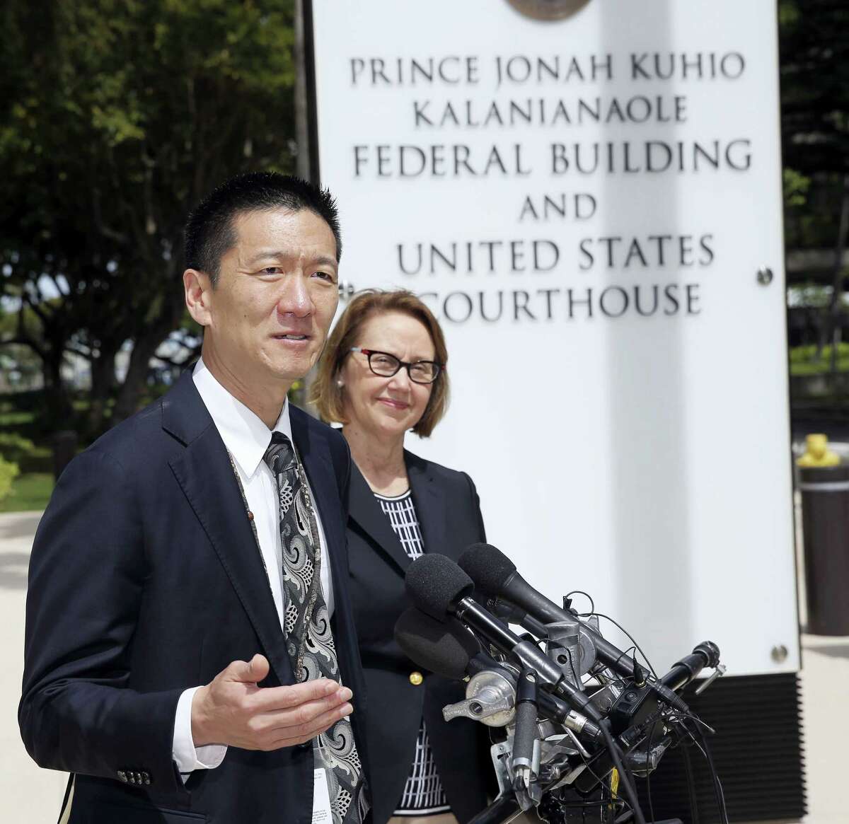 Hawaii Attorney General Douglas Chin, left, and Oregon Attorney General Ellen Rosenblum speak at a press conference outside the federal courthouse, Wednesday, March 15, 2107, in Honolulu. Hearings were scheduled Wednesday in Maryland, Washington state and Hawaii on President Donald Trump’s travel ban. The lawsuit claims the ban harms Hawaii by highlighting the state’s dependence on international travelers, its ethnic diversity and its welcoming reputation as the Aloha State.