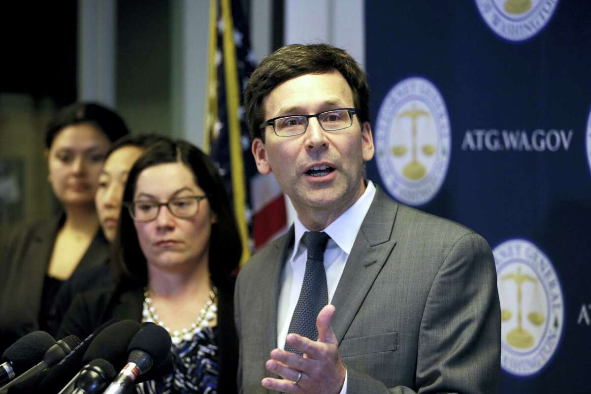 FILE - In this March 9, 2017, file photo, Washington State Attorney General Bob Ferguson speaks at a news conference about the state’s response to President Trump’s revised travel ban in Seattle, Wash. The day before it is supposed to go into effect President Donald Trump’s revised travel ban will be scrutinized in federal courtrooms across the country on Wednesday, March 15, 2017. Ferguson is pushing for a hearing before Judge James Robart, who halted the original ban last month. Ferguson wants Robart to apply the ruling to the new ban.