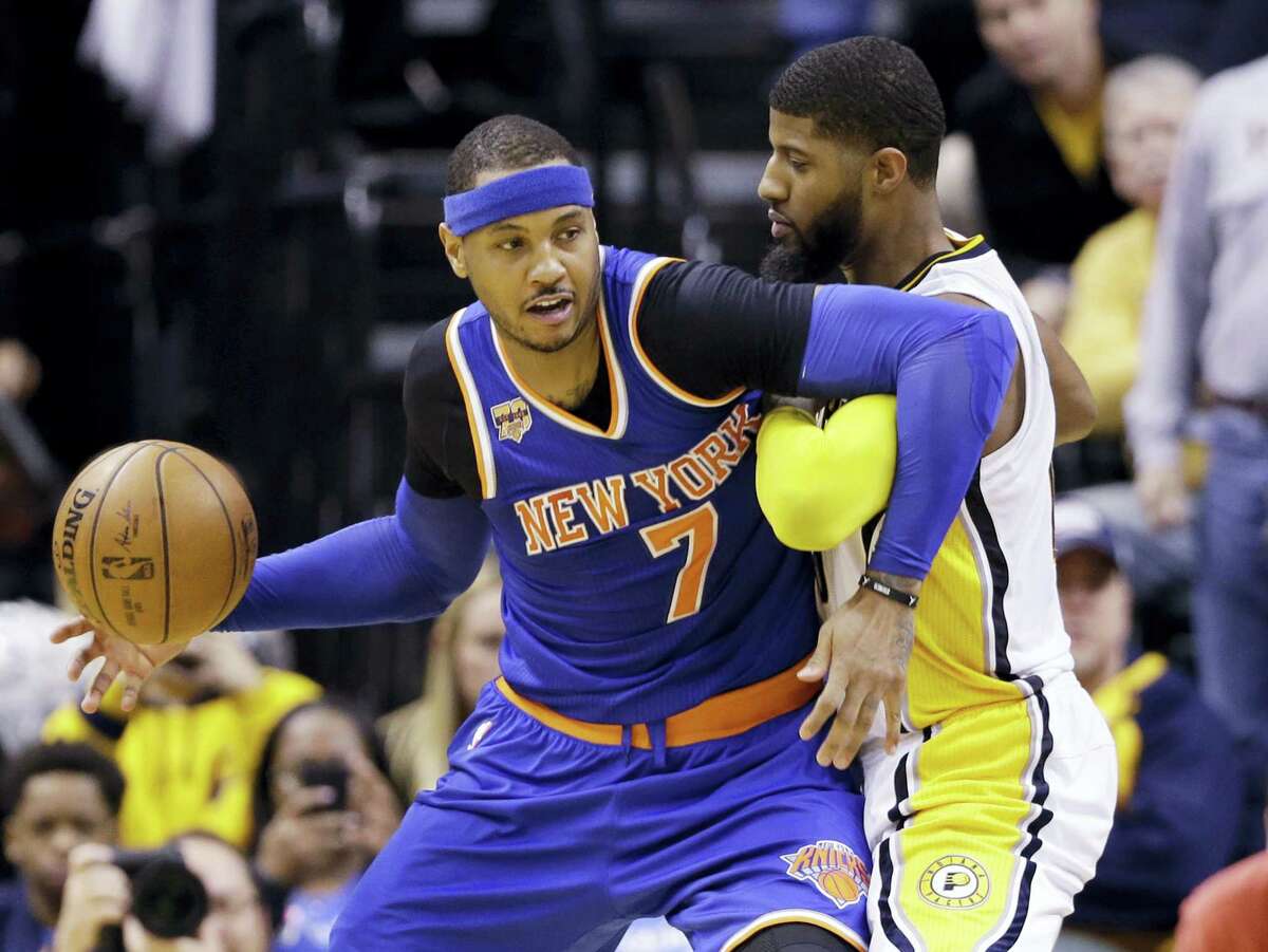 New York Knicks forward Carmelo Anthony (7) works against Indiana Pacers forward Paul George (13) during the second half of an NBA basketball game in Indianapolis on Jan. 23, 2017. The Knicks defeated the Pacers 109-103.